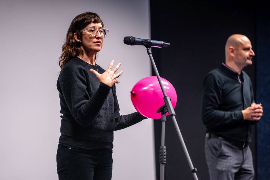Filmmaker Alison O'Daniel on stage with pink balloon in her hand